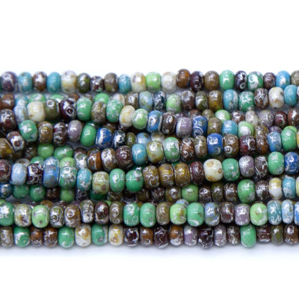 6SB5699R: CZ Seed Bead Aged Picasso Travertine Luster Mix 6/0 6 Strings