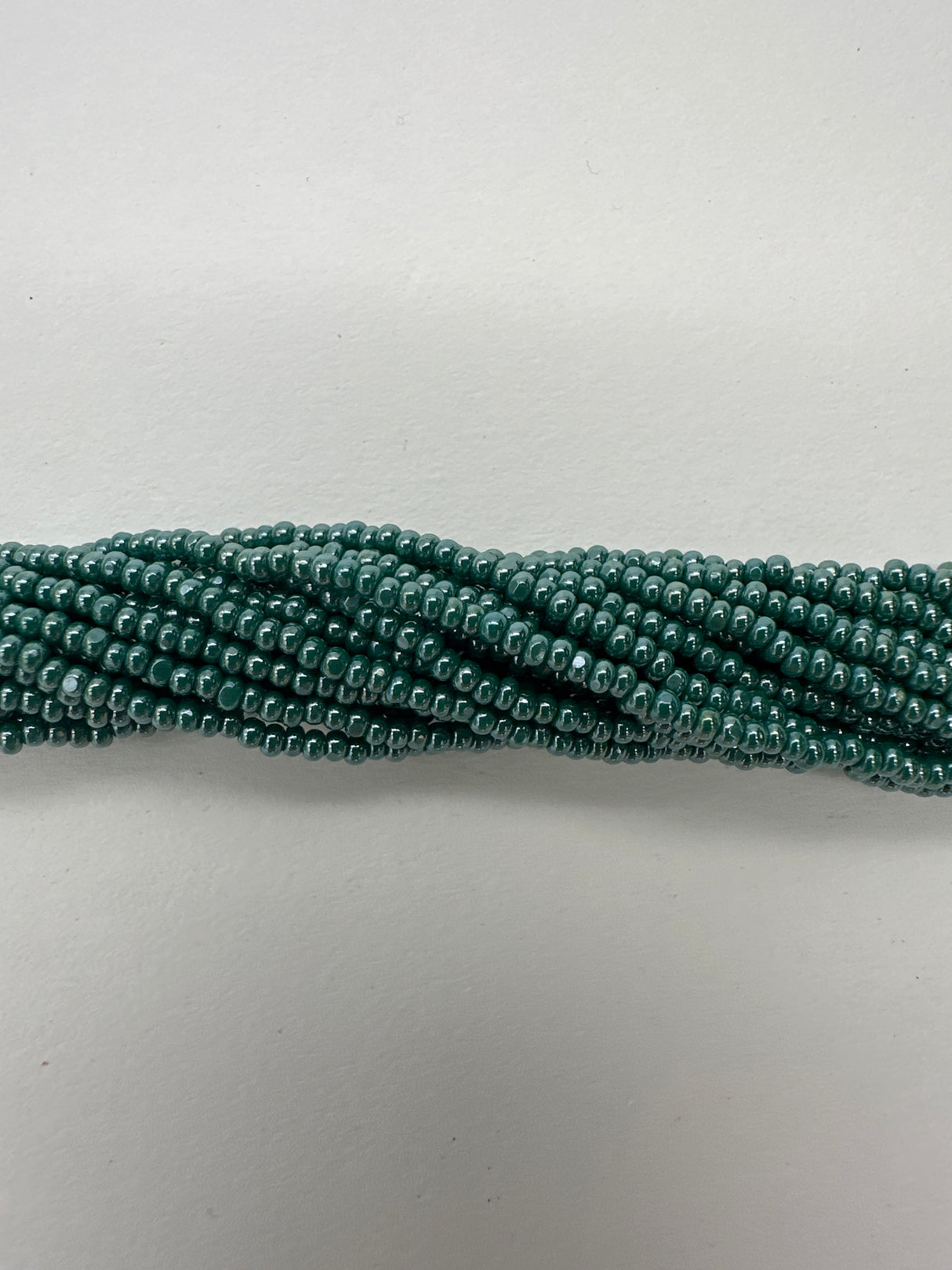 11SB386-CR: CZ Seed Bead True Cut Sfinx DK Green 11/0 1HK